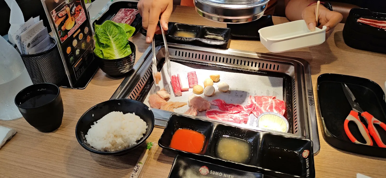 Sliced beef and rice at the tabletop grill