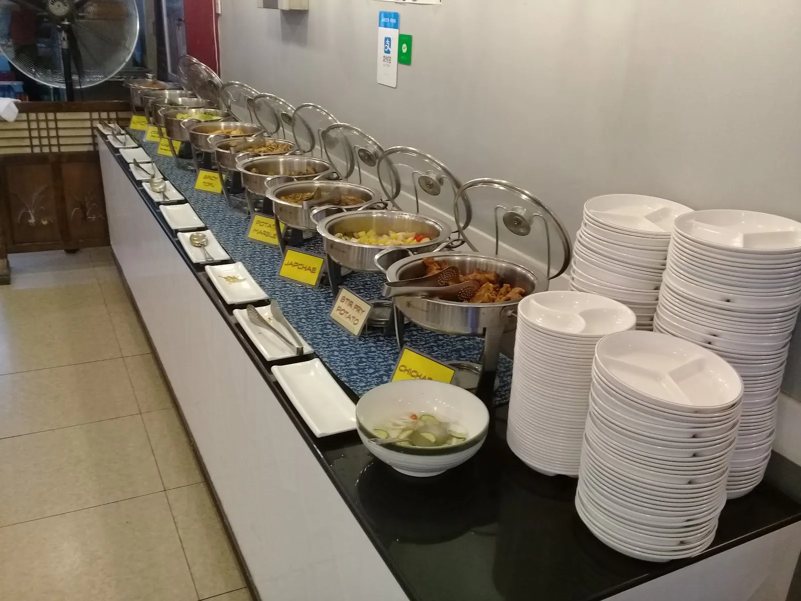 Buffet counter with side dishes and plates