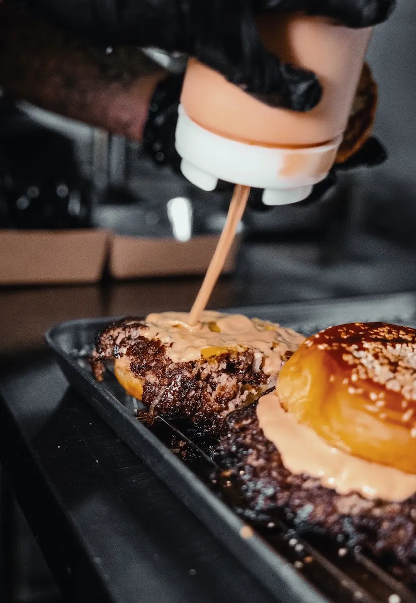 Sauce drizzled on burger patties