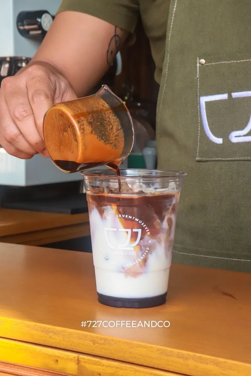 Barista pouring an iced coffee