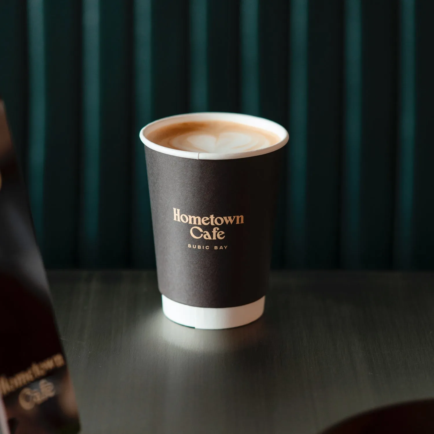 Takeaway cup with Hometown Cafe branding