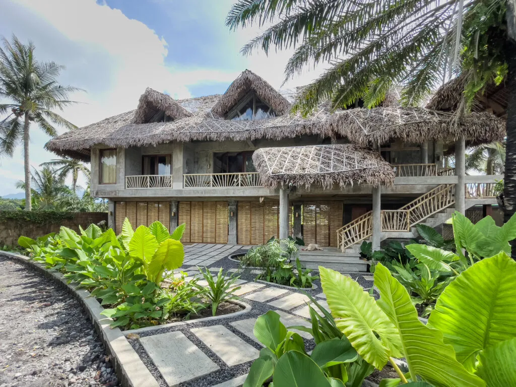 Stilt house exterior among palms