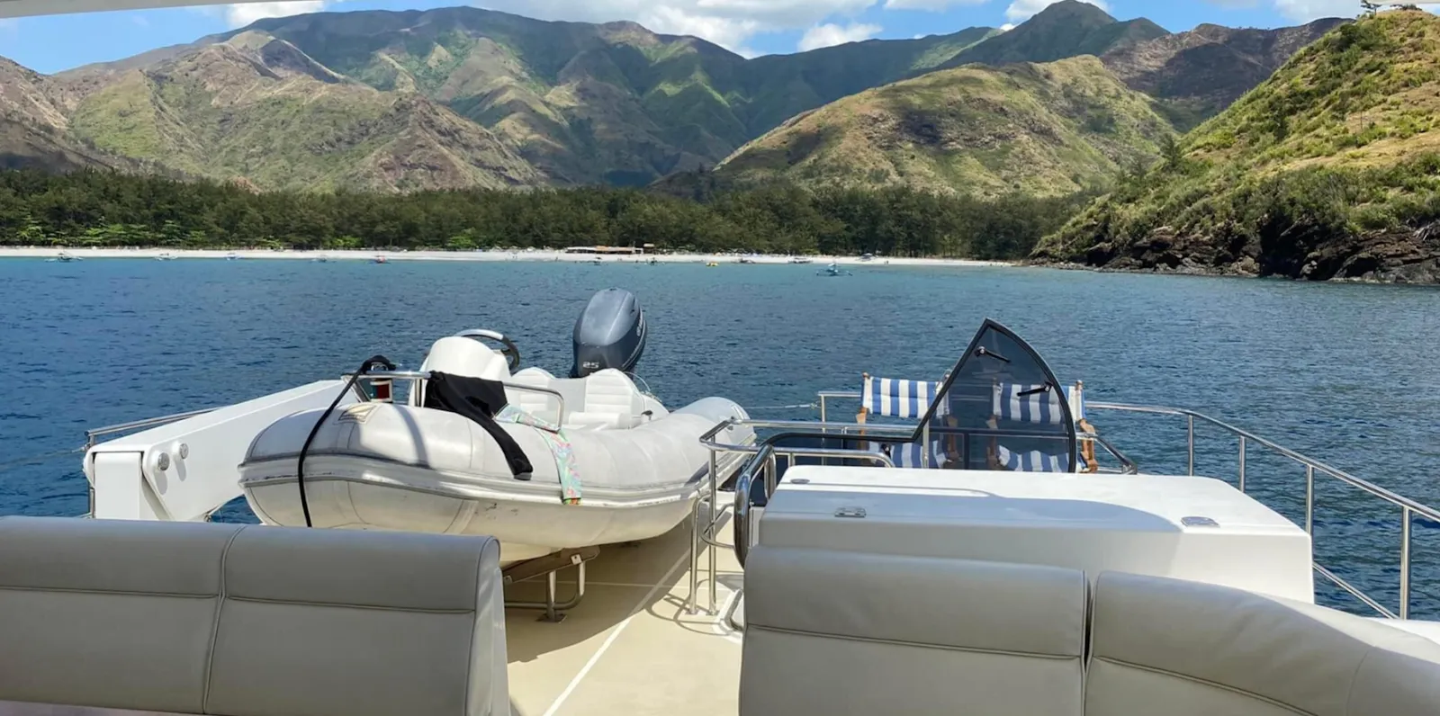Tender boat on deck along the coast