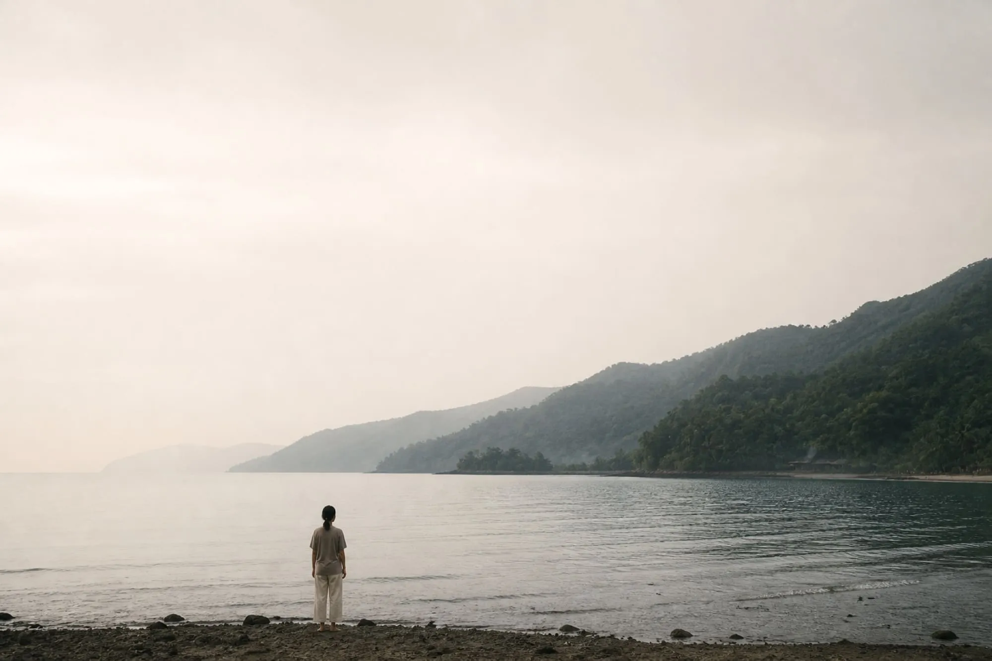 A quiet moment beside Subic Bay, with calm water and forested hills in the morning light.